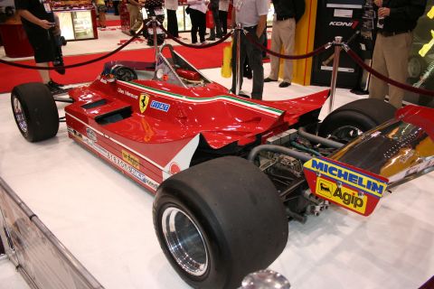 1998 Ford Crown Victoria - Rear three-quarter view of a red vintage Ferrari Formula 1 car with Michelin slick tires and FIAT and Agip sponsor decals.