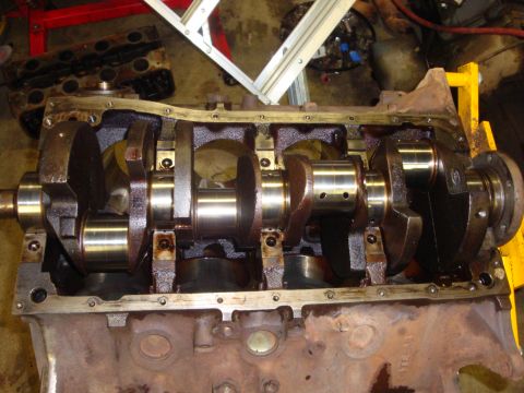 1989 Ford Bronco - Close-up view of an engine block's crankshaft and internal components, likely during a repair or cleaning process.
