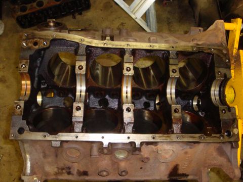 1989 Ford Bronco - Close-up view of an engine block's crankshaft bearing saddles and main bearing caps.