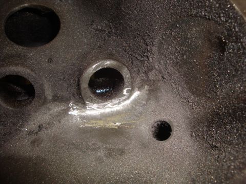 1989 Ford Bronco - This is a close-up view of an engine's cylinder head, showing significant carbon deposits and valve ports.