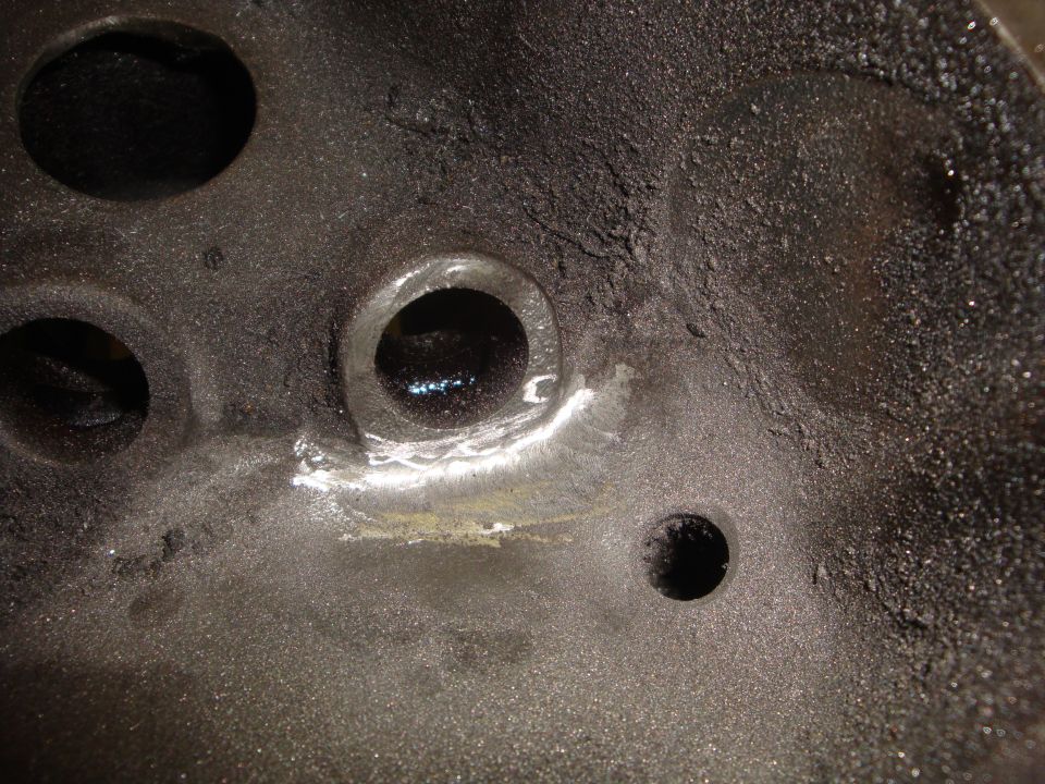 close-up of engine cylinder head with carbon buildup and valve openings