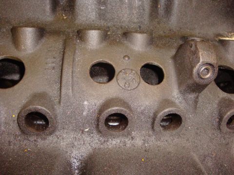 1989 Ford Bronco - Close-up of an engine block casting with a circular stamp indicating the year '91'.