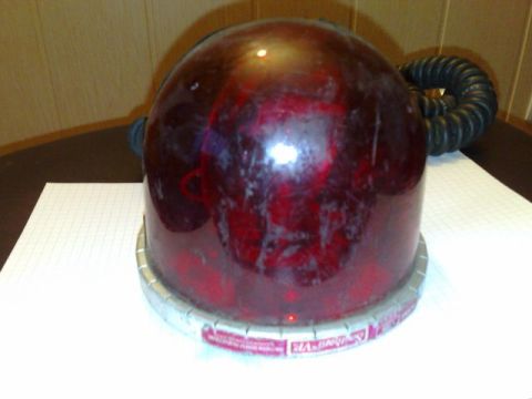1991 Ford Crown Victoria - A red emergency light with a silver base and a black hose is shown.