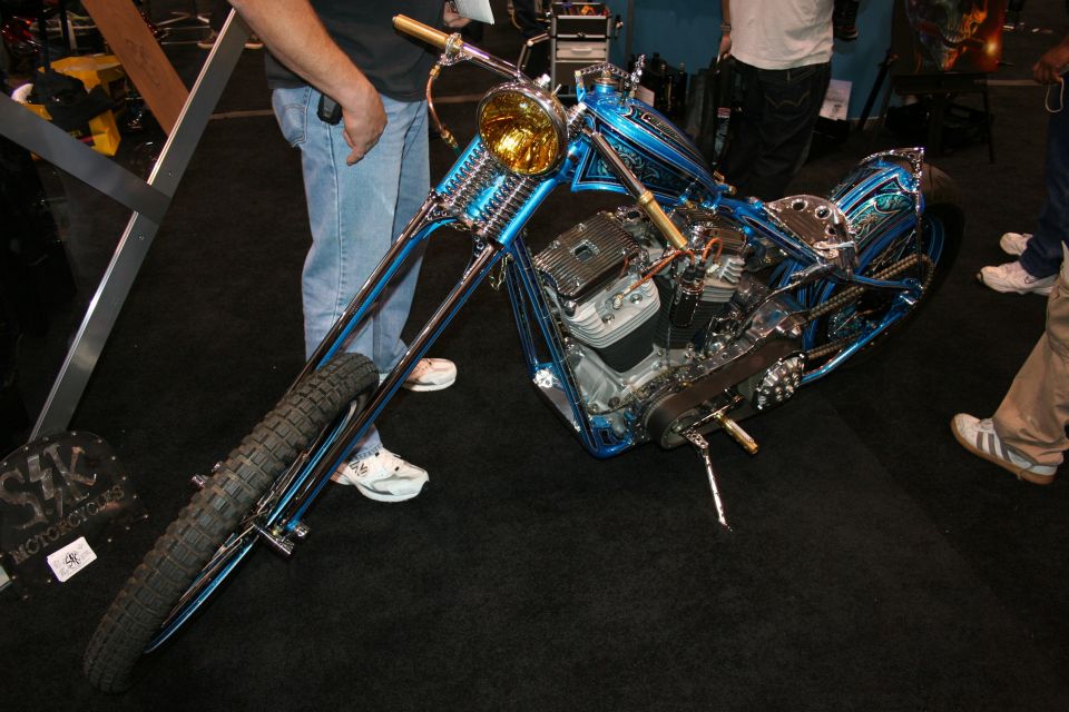 Blue custom chopper motorcycle on black show carpet