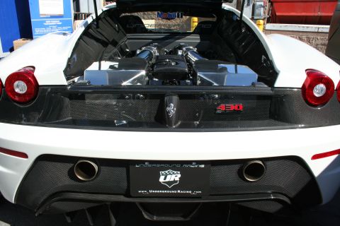 1998 Ford Crown Victoria - open rear engine bay of a white Ferrari shows a 430 Scuderia badge and an Underground Racing license plate between dual exhausts.