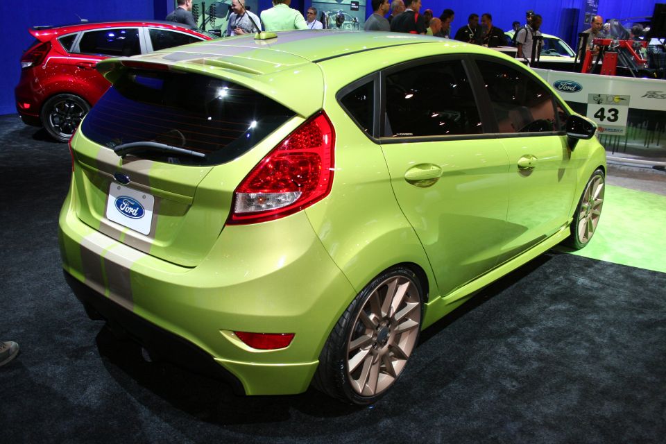 Green Ford Fiesta hatchback rear three-quarter at indoor show