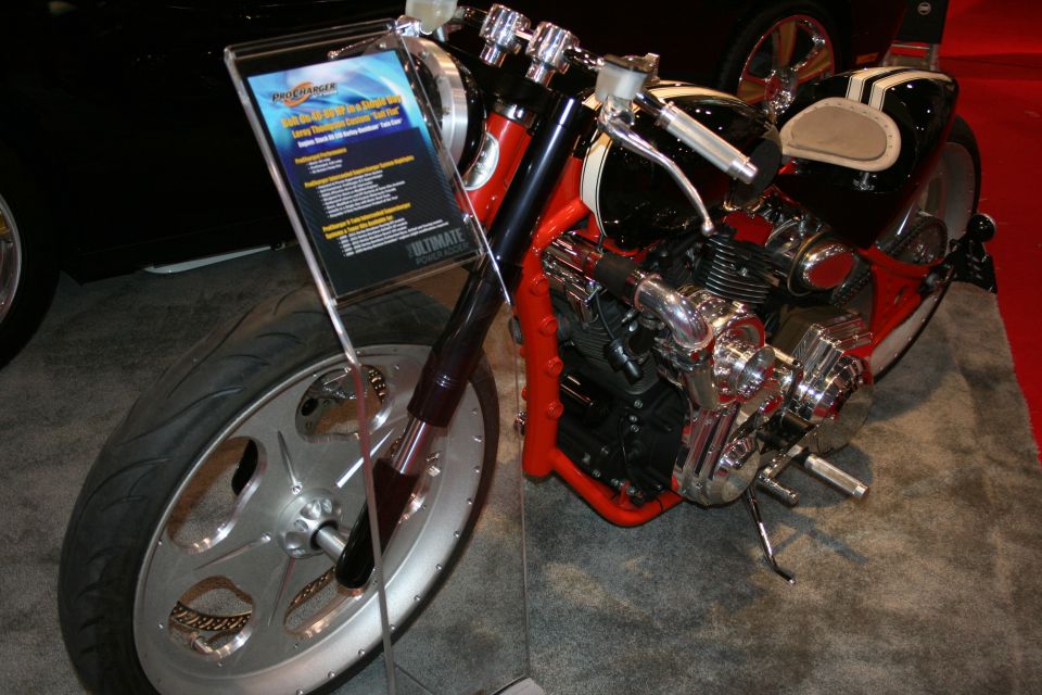 Custom chopper motorcycle with chrome V-twin engine on display