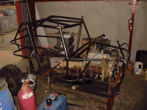 1994 Ford Bronco - A custom-built buggy frame is shown with its engine and roll cage in a workshop.