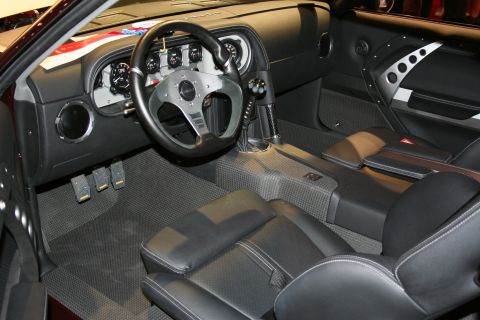 1998 Ford Crown Victoria - Custom car interior showing a flat-bottom steering wheel, gauge cluster, three pedals and black leather seats.