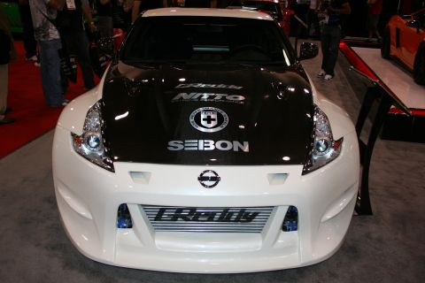 1998 Ford Crown Victoria - Front view of a white Nissan 370Z with a black hood, large intercooler and Seibon and GReddy decals.