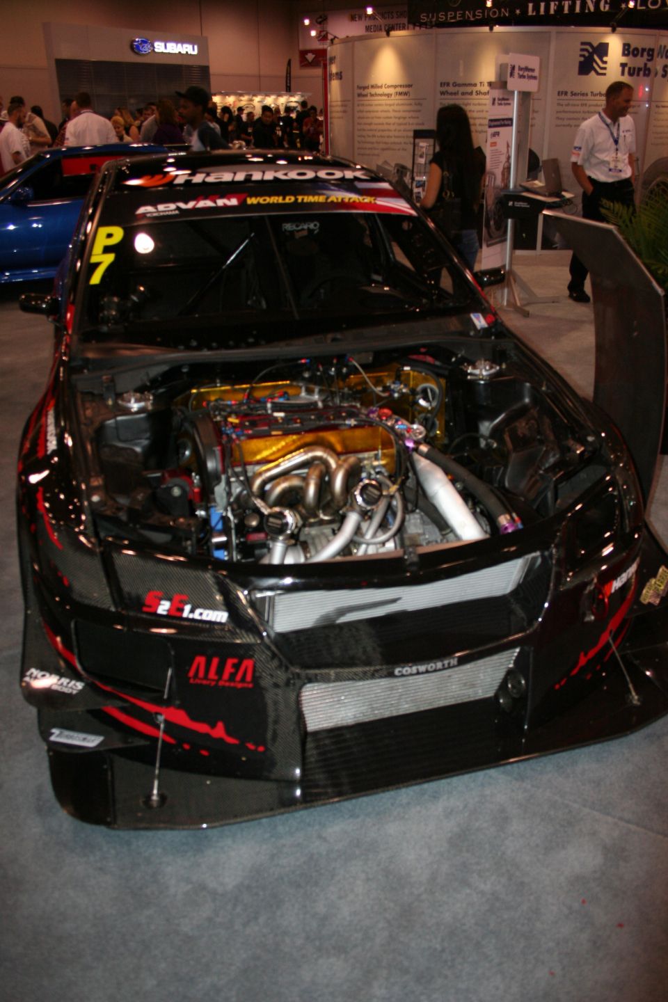 Black widebody time-attack race car with hood open, Hankook windshield banner