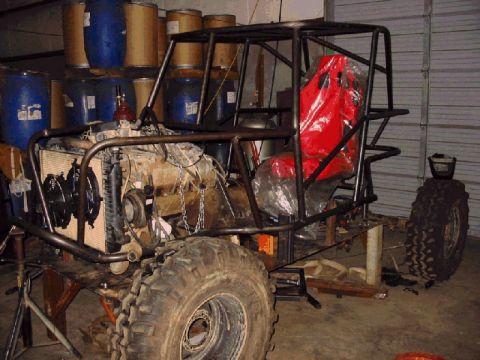 1994 Ford Bronco - Custom off-road buggy frame with engine and racing seat, appears to be under construction.