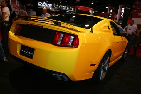 1998 Ford Crown Victoria - Rear three-quarter view of a yellow Saleen Mustang with a rear spoiler and Saleen license plate at a trade show.