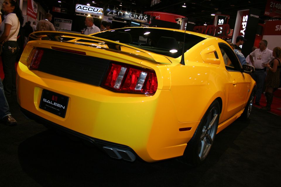 Rear three-quarter of a yellow Saleen Mustang with spoiler at a show