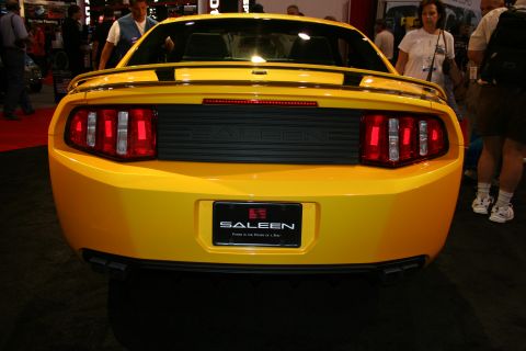 1998 Ford Crown Victoria - rear of a yellow Saleen Mustang showing the taillights, a black center panel and a Saleen license plate.