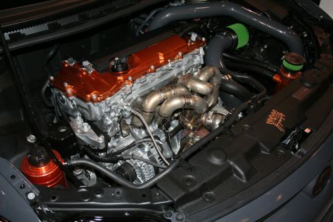 1998 Ford Crown Victoria - Detailed engine bay showing an orange-anodized valve cover, polished turbo manifold and green-filtered intake.