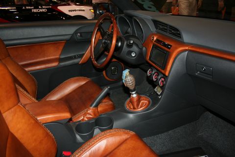 1998 Ford Crown Victoria - Custom interior with tan leather seats, a wood-rimmed steering wheel and a grenade-shaped manual shift knob.