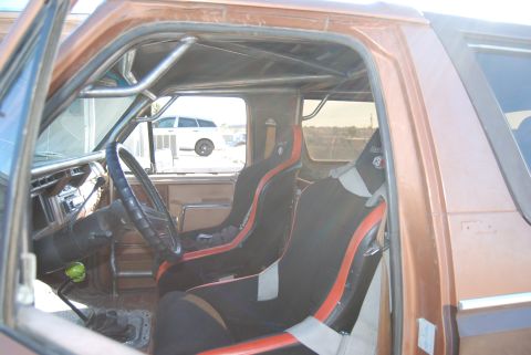 1982 Ford Bronco - Interior view of a 1982 Ford Bronco showing racing seats and a roll cage.