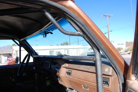 1982 Ford Bronco - The interior of a modified SUV shows a custom roll cage installed around the cabin.