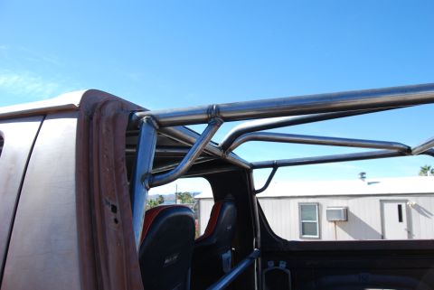 1982 Ford Bronco - Custom roll cage installed inside a vehicle, with seats visible.