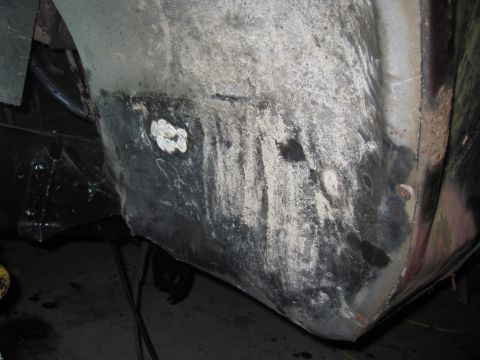 1979 Ford Bronco - Close-up view of the interior of a vehicle's wheel well, showing signs of rust and repair work.
