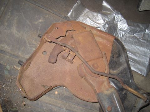 1979 Ford Bronco - A close-up view of a corroded mechanical brake component, likely from a vehicle.