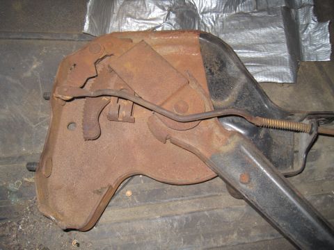 1979 Ford Bronco - A close-up view of a heavily rusted parking brake mechanism, showing its internal components and linkage.