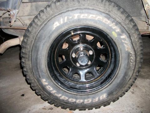 1992 Jeep Cherokee - Close-up of a BFGoodrich All-Terrain T/A tire mounted on a black steel wheel.