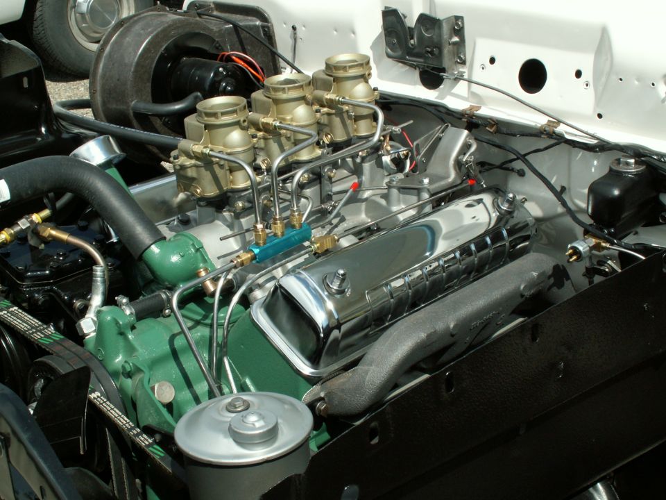 Close-up of a V8 engine with four carburetors and chrome valve covers