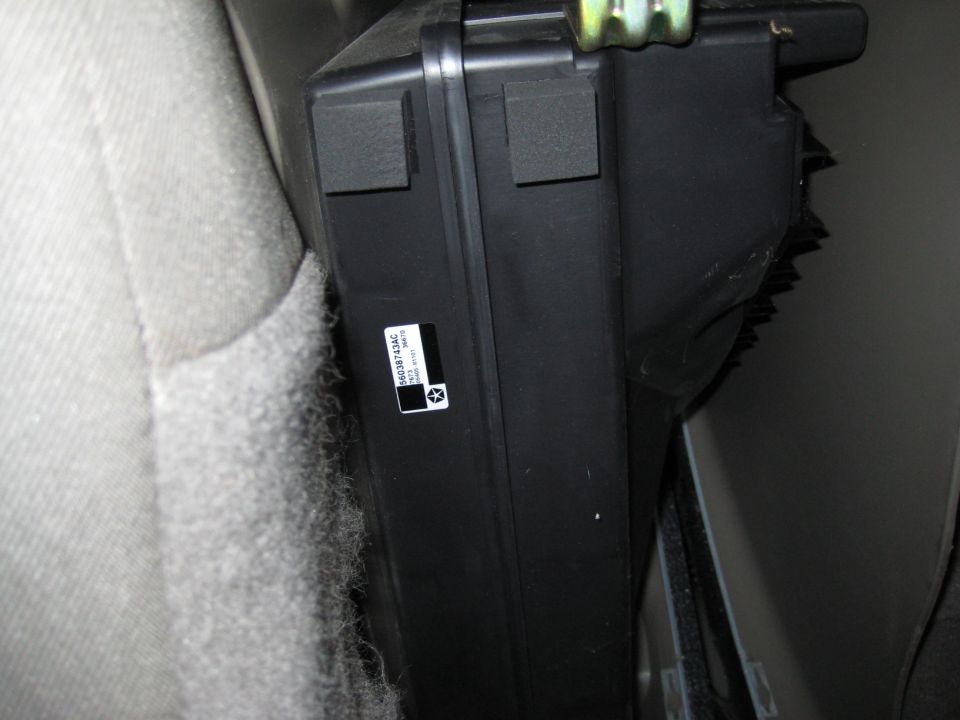 Black Mopar module with pentastar part-number label 56038743AC mounted behind interior trim