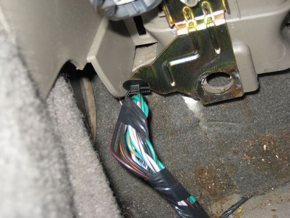 Wiring harness bundle secured with zip tie under dashboard