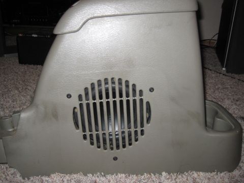 2005 Jeep Wrangler - This gray center console features a speaker grille and appears to be a part removed from a vehicle.