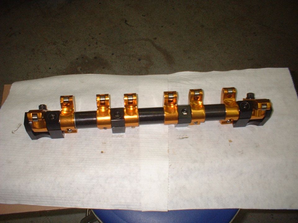 Gold and black roller rocker arm assembly