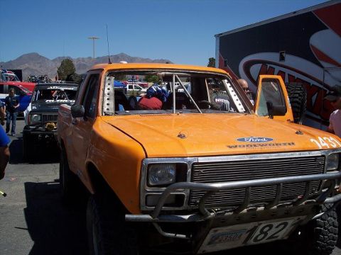 1986 Ford Bronco - This modified 1986 Ford Bronco features a roll cage and racing decals, ready for off-road competition.