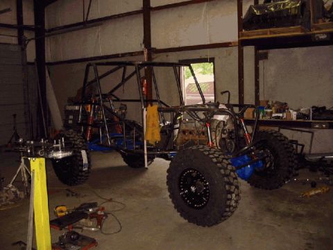 1994 Ford Bronco - Custom off-road buggy chassis being assembled in a garage with tools and parts visible.
