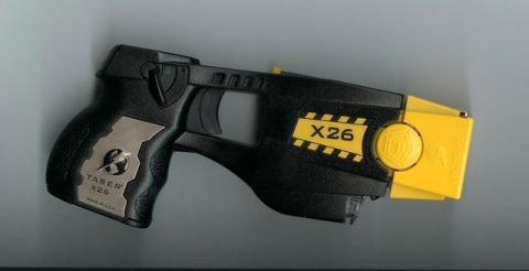 1991 Ford Crown Victoria - A black and yellow Taser X26 is shown against a gray background.