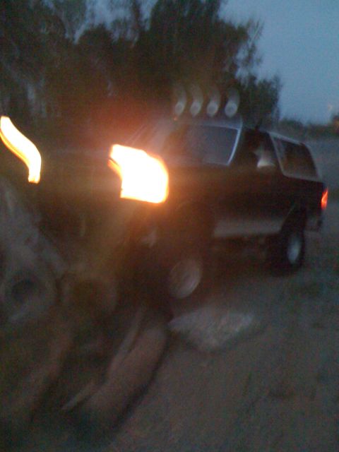 1992 Ford Bronco - 1992 Ford Bronco parked outdoors at dusk, equipped with roof-mounted auxiliary lights.