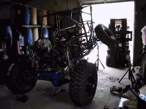 1994 Ford Bronco - A custom-built buggy is shown in a workshop, with a forklift visible in the open garage door.