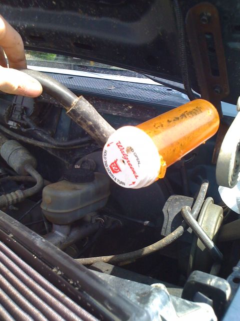 1992 Ford Bronco - A pill bottle cap is used to temporarily seal a hose in the engine bay.