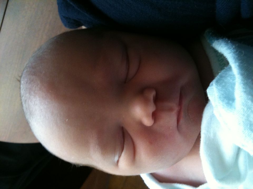 Sleeping baby with Supermotors logo in corner