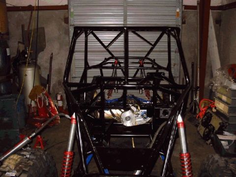 1994 Ford Bronco - The bare frame of an off-road buggy is visible, showing its suspension and engine bay.