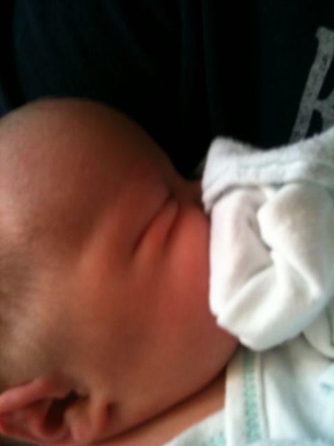 2000 Ford E350 - A close-up of a baby's head and shoulder, partially covered by a white blanket. The Supermotors logo is visible.
