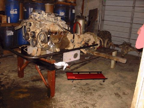 1994 Ford Bronco - Engine and transmission assembly disassembled and mounted on a stand for repair or rebuilding.