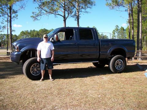 1992 Jeep Cherokee - Lifted Ford F-250 Super Duty pickup truck with flame decals parked outdoors.