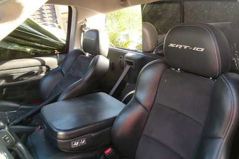 1972 Ford Ranchero - The interior of a truck shows black leather and suede seats with SRT-10 badging on the headrests.