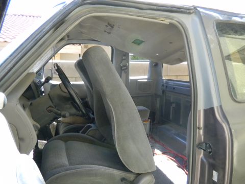 1997 Ford Ranger - Interior view of a 1997 Ford Ranger, showing cloth seats and the dashboard area with some exposed wiring visible.