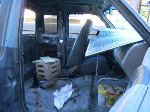 1997 Ford Ranger - The interior of a truck is shown with the seats removed and the floor exposed, indicating ongoing work.