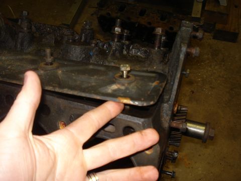 1991 Ford Bronco - Engine block detail with gears and a hand indicating a component. The SuperMotors logo is visible.