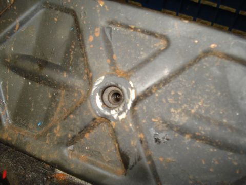 1991 Ford Bronco - This image shows a close-up view of a dirty and rusty metal component, likely from a vehicle's undercarriage.