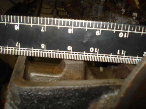 1991 Ford Bronco - Close-up of an engine component with a ruler for scale, indicating measurements.